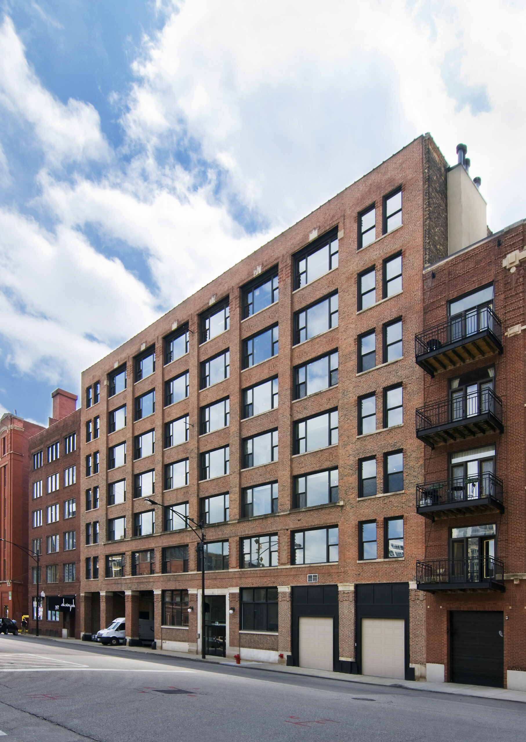 Exterior view of 363 West Erie St., Chicago, IL 60654, a brick and timber loft building with large windows in the heart of the River North district.